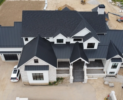Custom built home with a black metal roof in Cambridge, ON